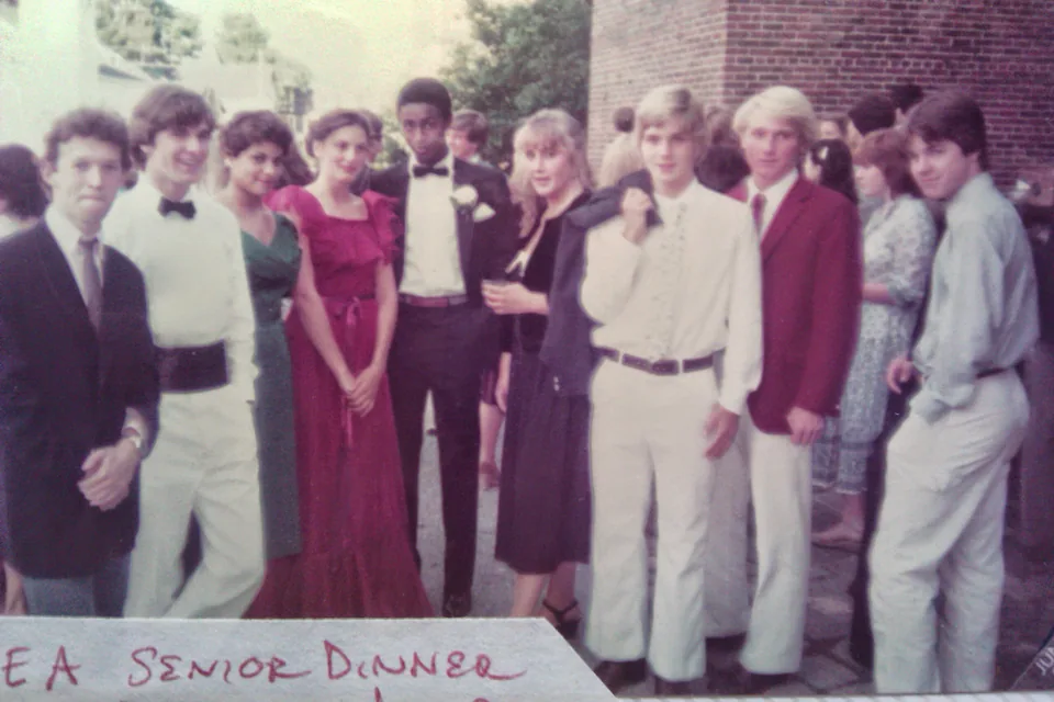 A group of Phillips Exeter seniors in evening dress outside a brick building at the senior dinner, 1982, with the handwritten label 'PEA Senior Dinner'.
