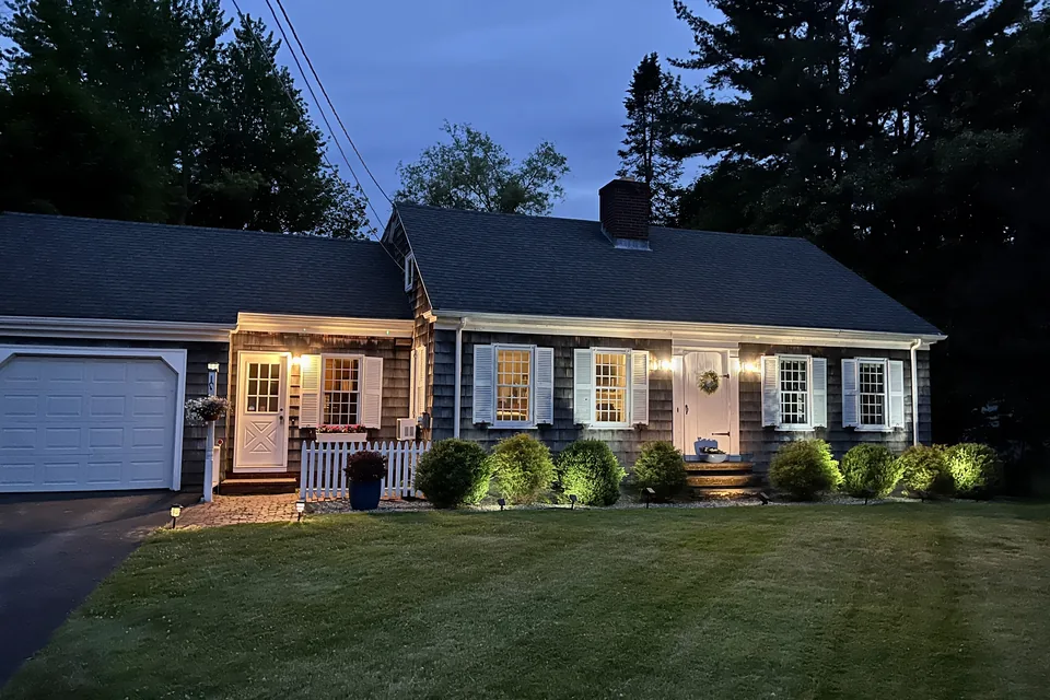 The house in Saco lit up at night.